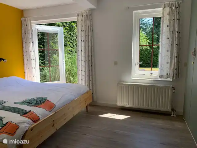 Schouwseduin 12 | Pays-Bas, Zélande, Burgh-Haamstede - maison de vacances chambre au rez-de-chaussée avec lit double, portes-fenêtres donnant sur la cour arrière, évier et placard.