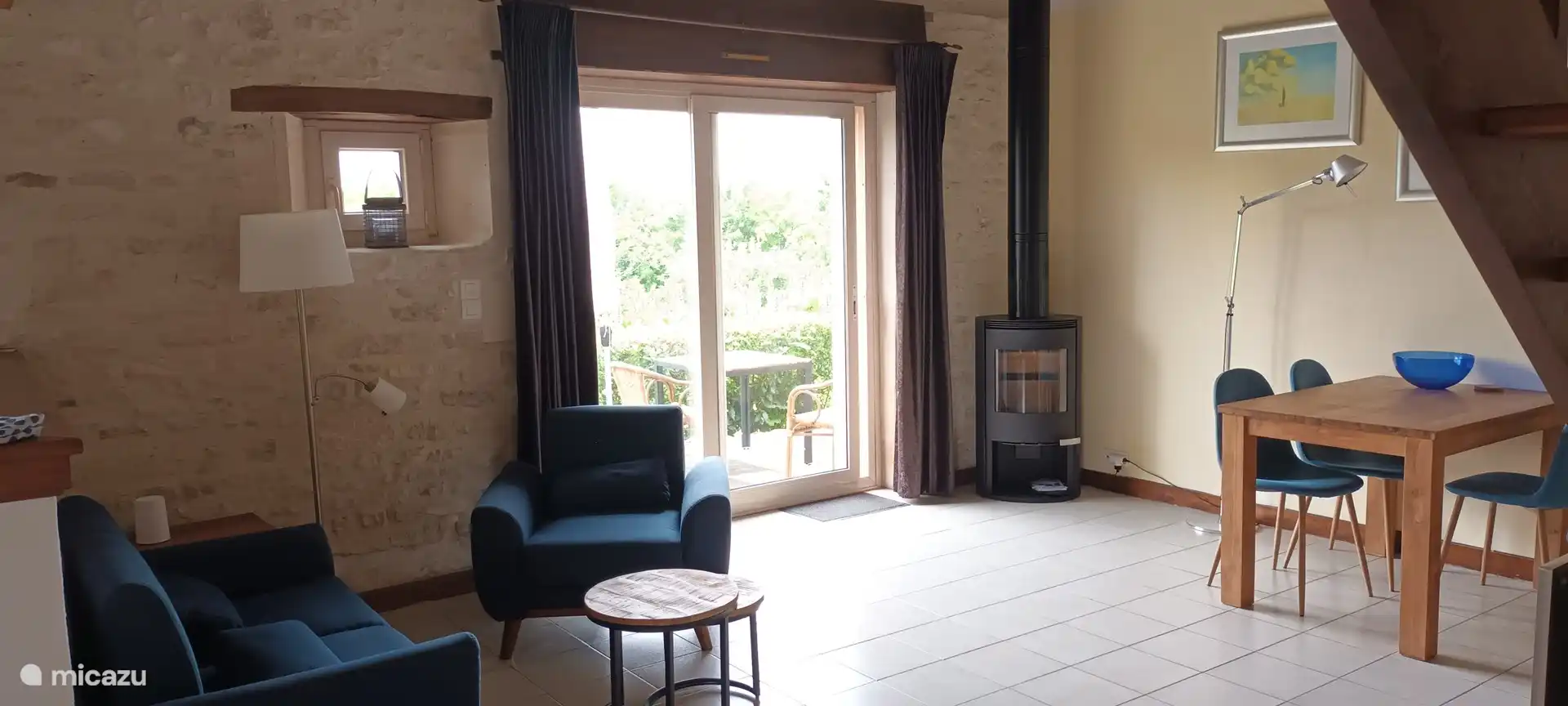 The sitting area and dining table with wood stove