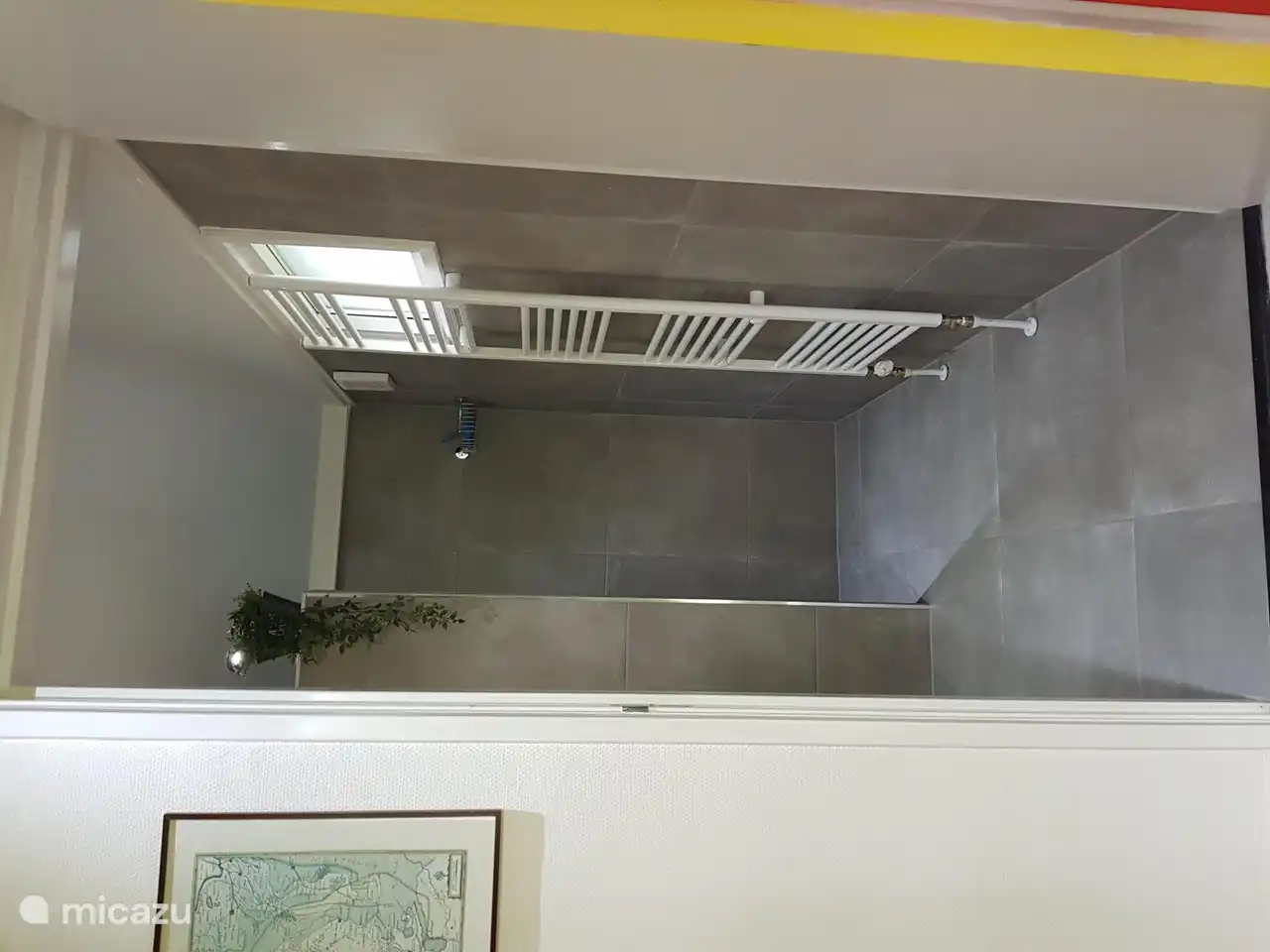 Towel radiator on central heating and electric underfloor heating in new bathroom