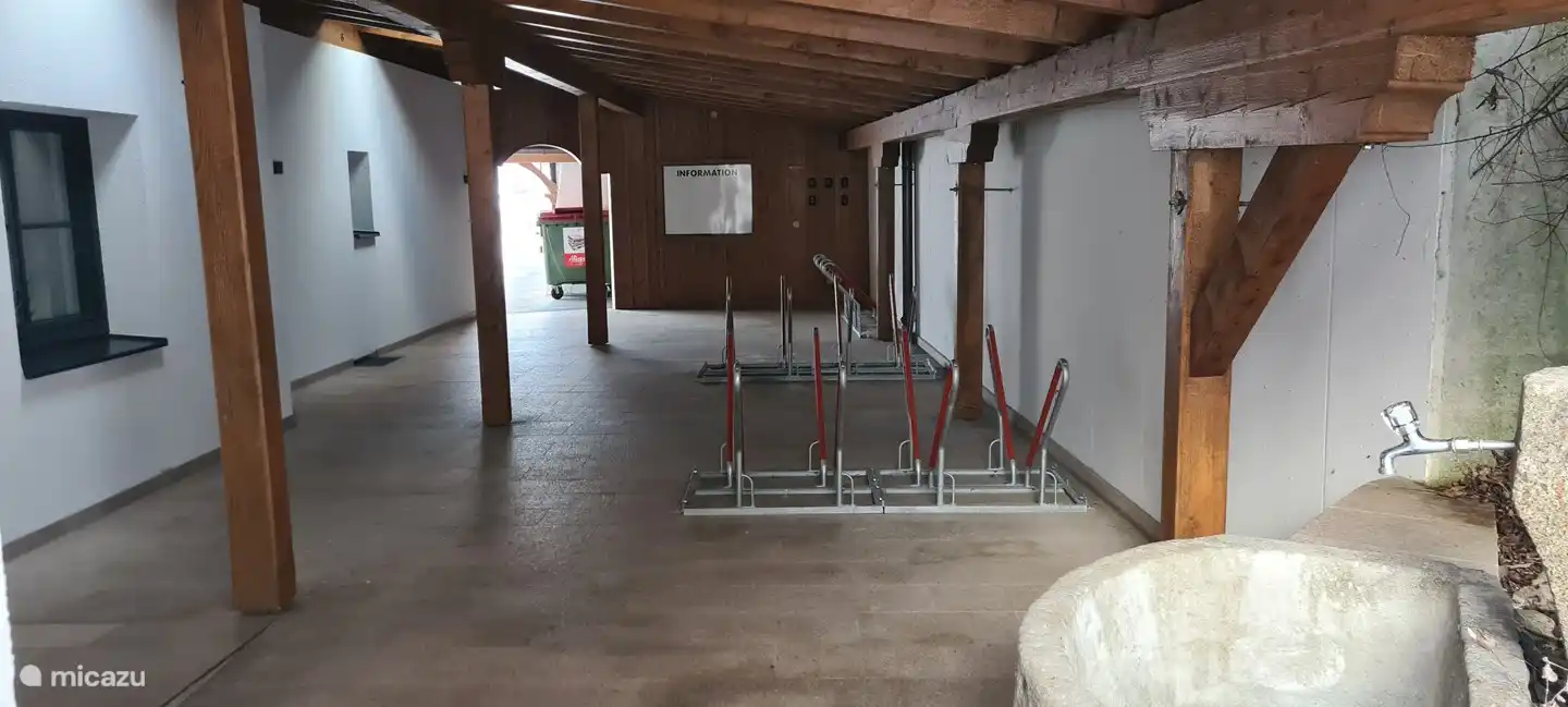 Covered bicycle shed and key box wall