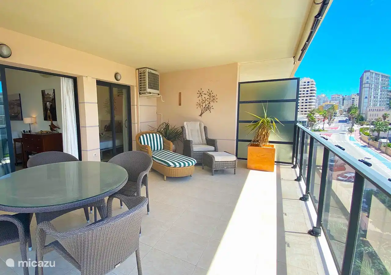 terrace with dining table and 2 sunbeds