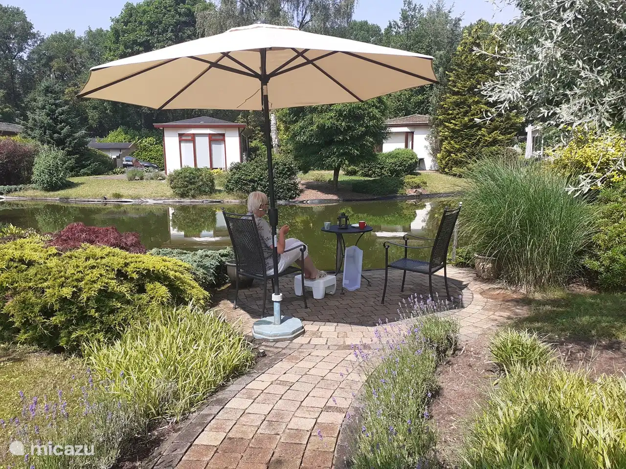 Also at the pond is a second seat, possibly with a parasol.