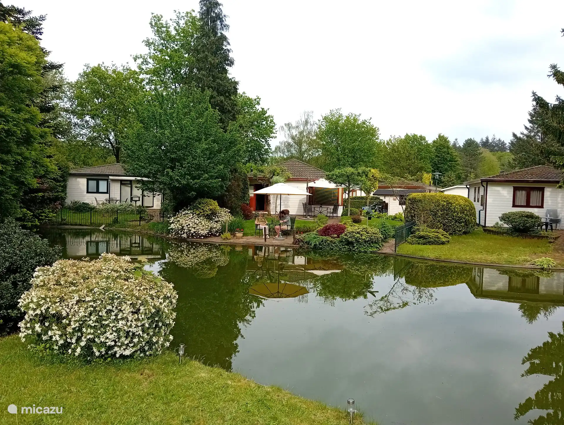 Seat from the other side of the pond. You can see the beautiful blooming garden. With the comfortable seating area possibly with parasol.
