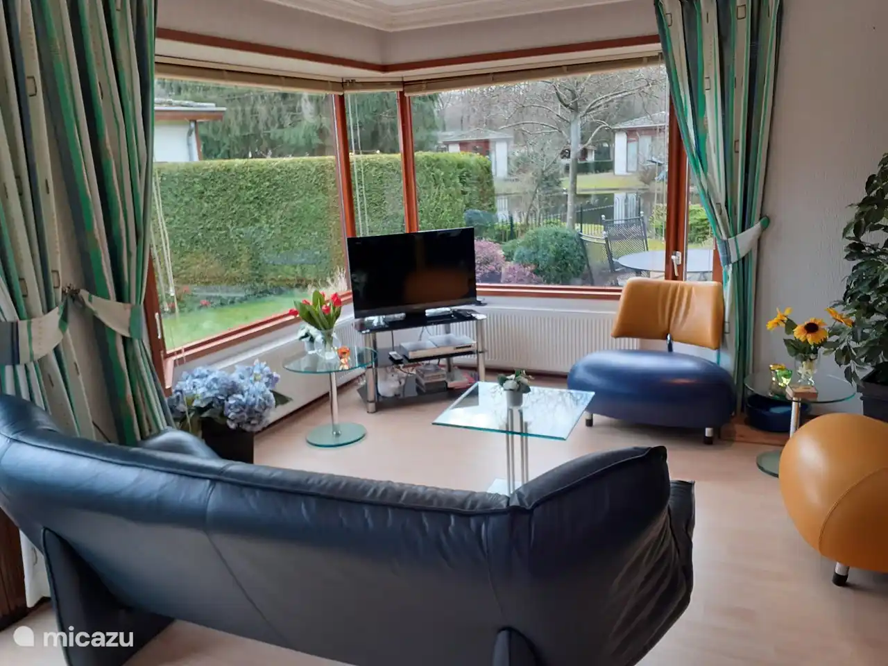 Beautiful room with open kitchen and a great view of our artwork and the rustic pond.