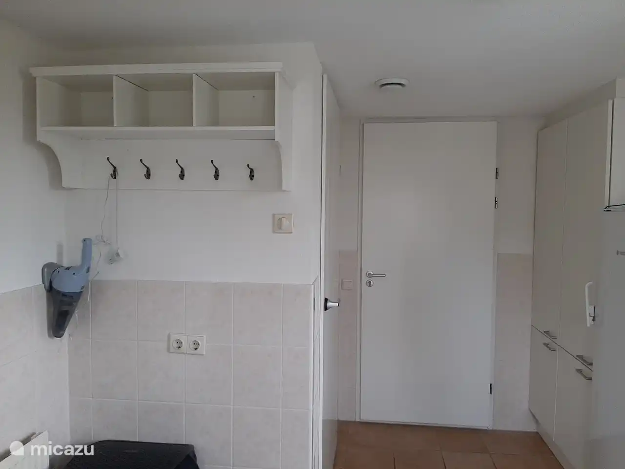 The utility room, containing a washing machine and dryer