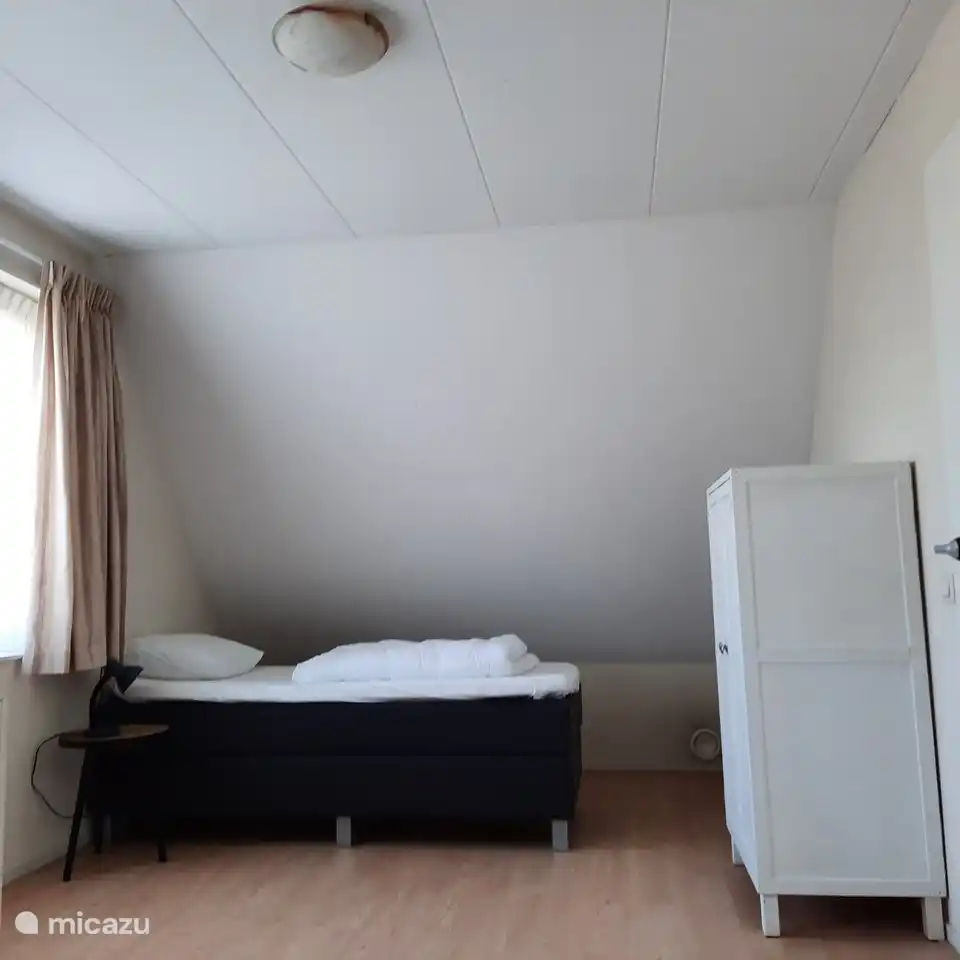 Bedroom on the first floor with two single box-spring beds.