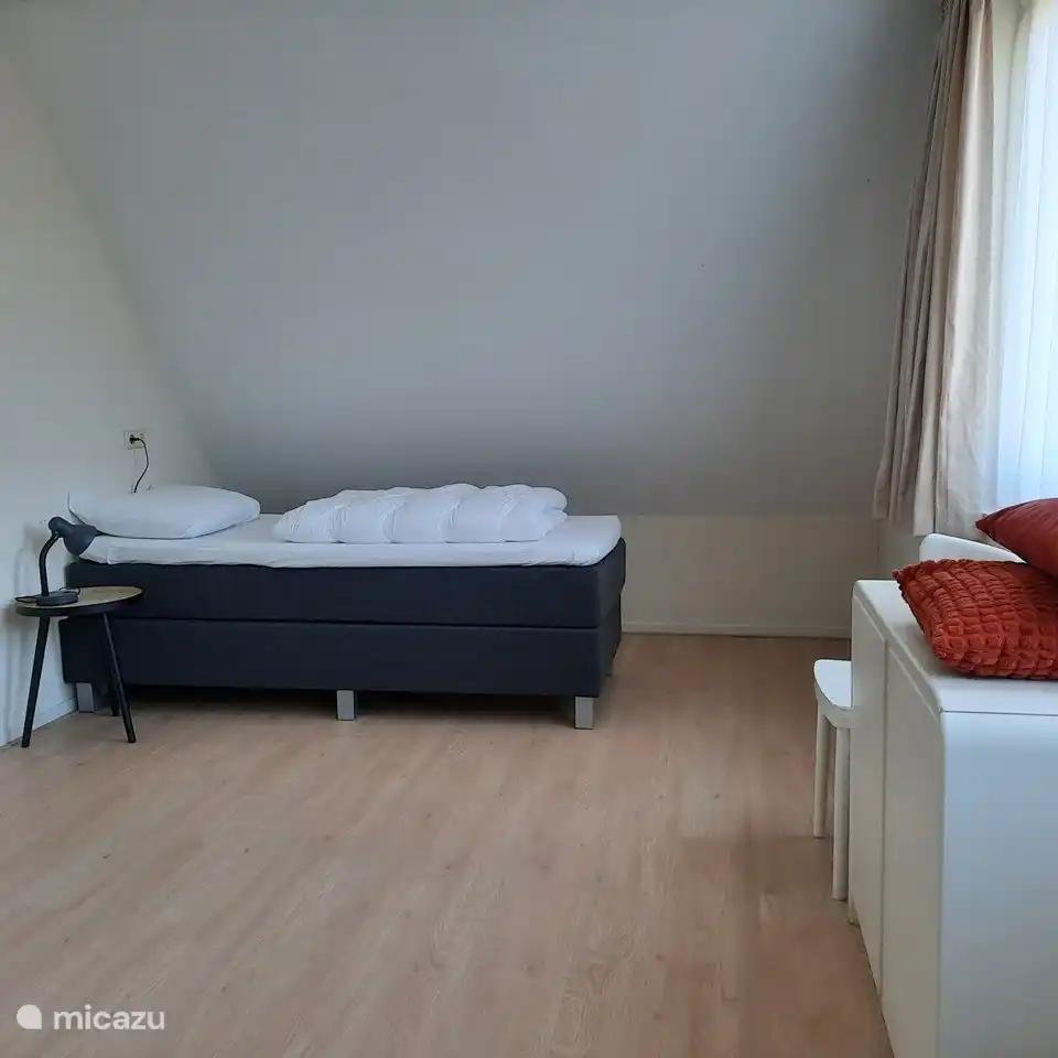 Bedroom on the first floor with two single box-spring beds.