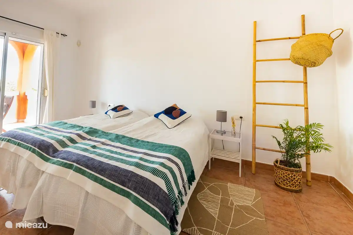 la chambre principale est très spacieuse, avec des lits luxueux et une salle de bains luxueuse attenante, avec une grande fenêtre coulissante donnant sur une terrasse privée et la climatisation