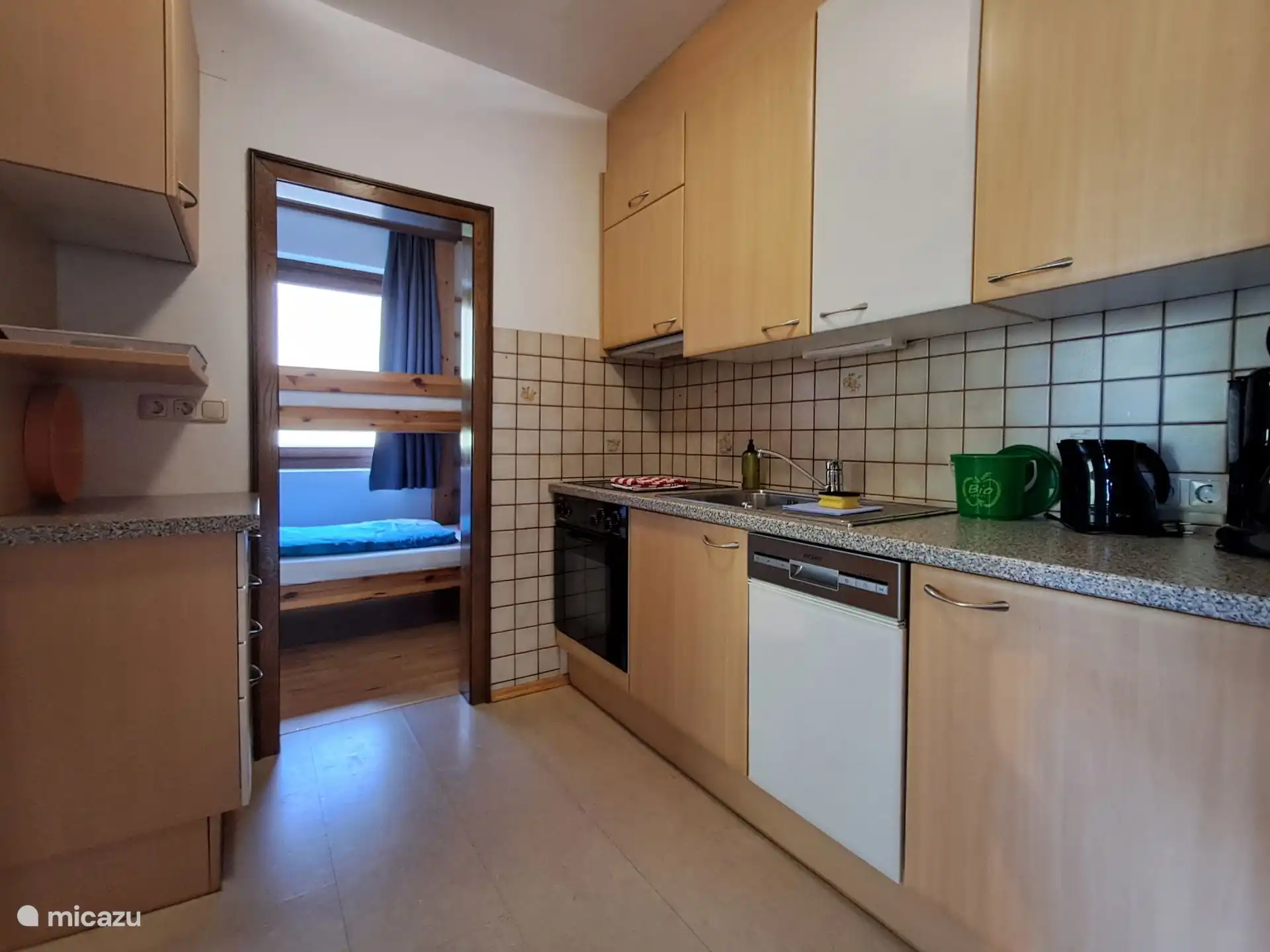 Keuken vakantiewoning Anemoon met koelkast met vriesvak, afwasmachine, keramische kookplaat met oven en alles wat nodig is om een lekkere maaltijd te koken.
