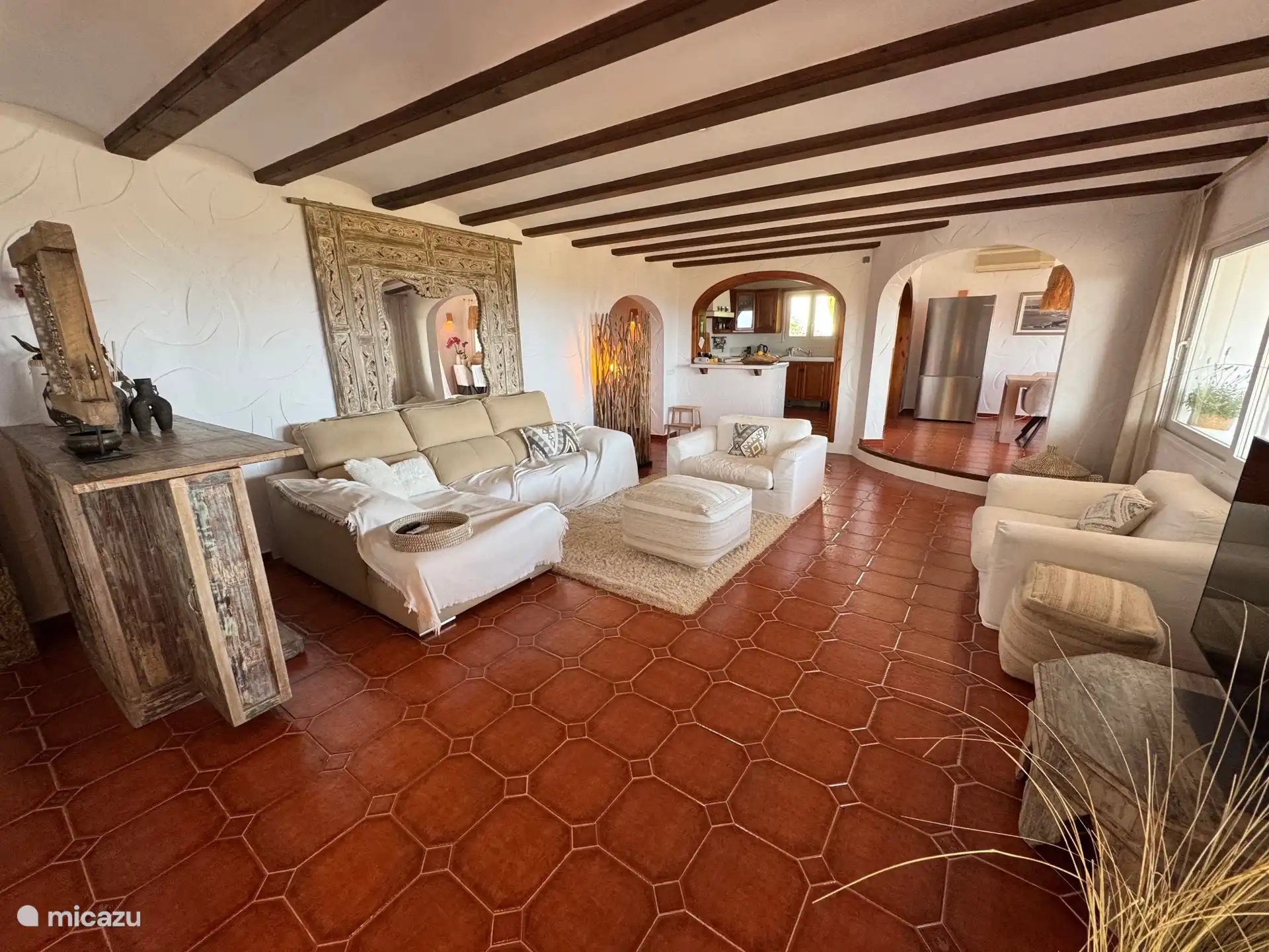 Spacious and attractive living room with a view through to the kitchen and dining room