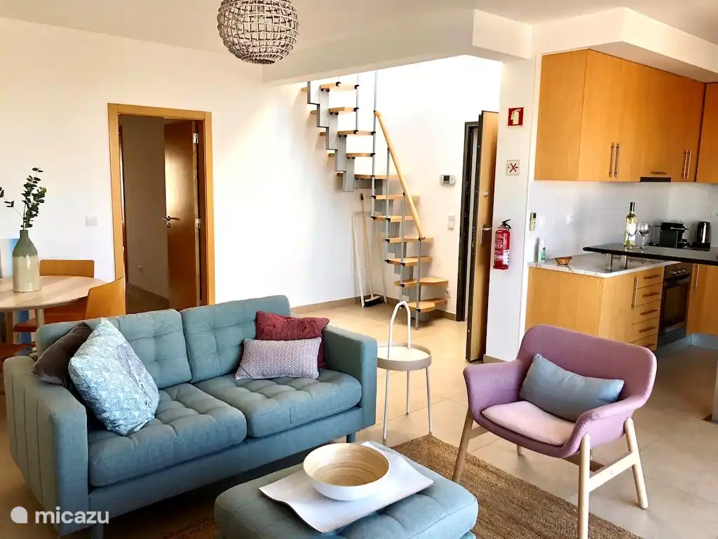 sala de estar con cocina abierta y escaleras a la azotea