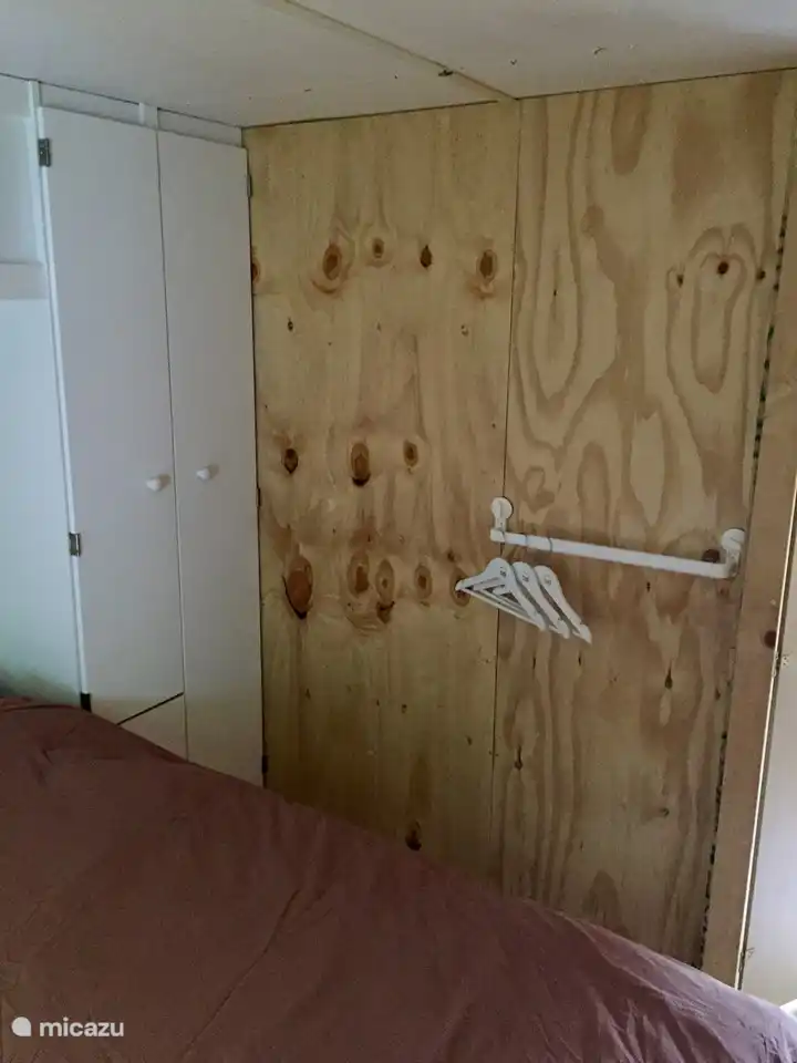 Das Schlafzimmer mit dem Doppelbett hat einen großen Kleiderschrank.