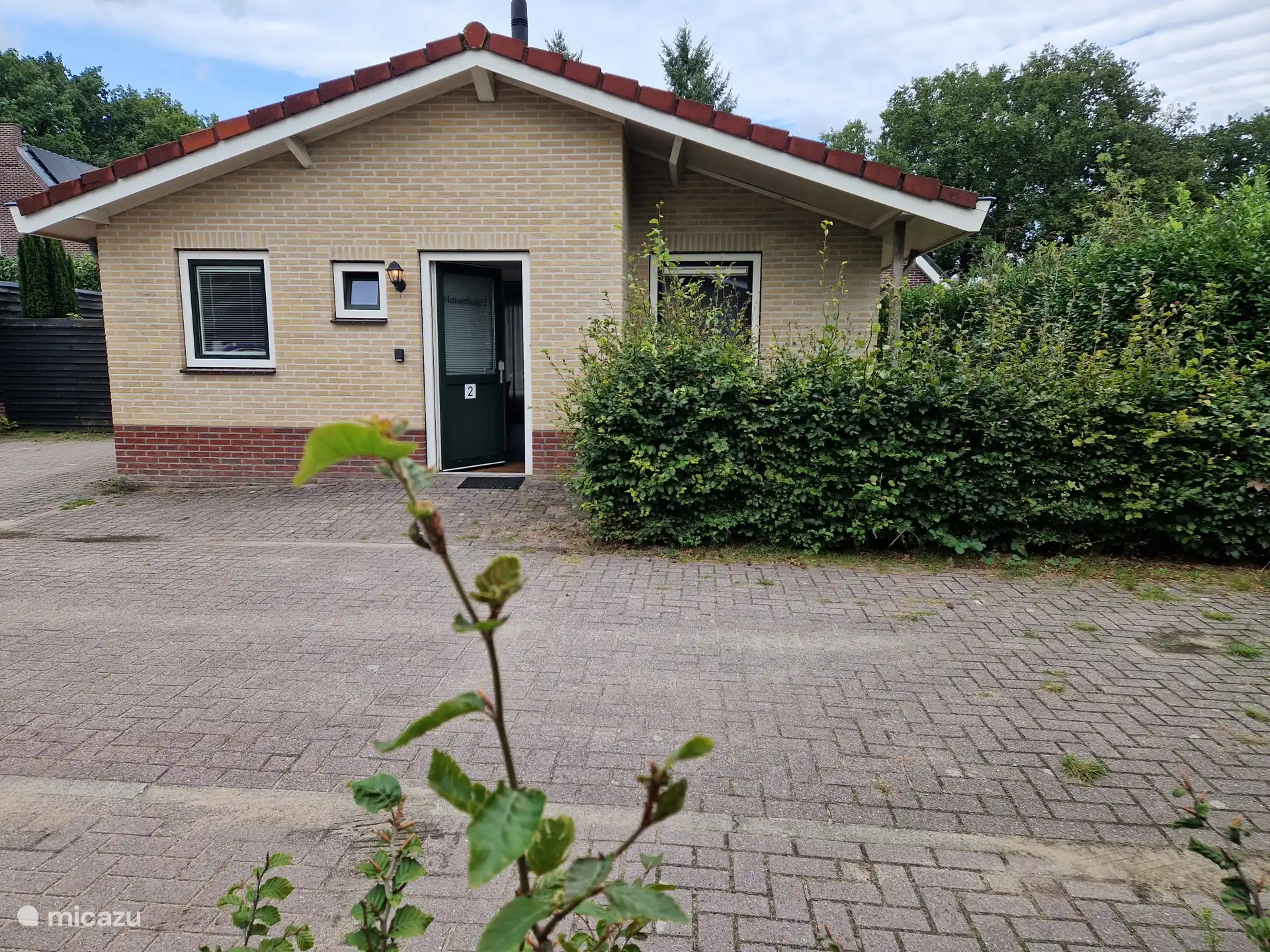 Front with private parking space on the left.