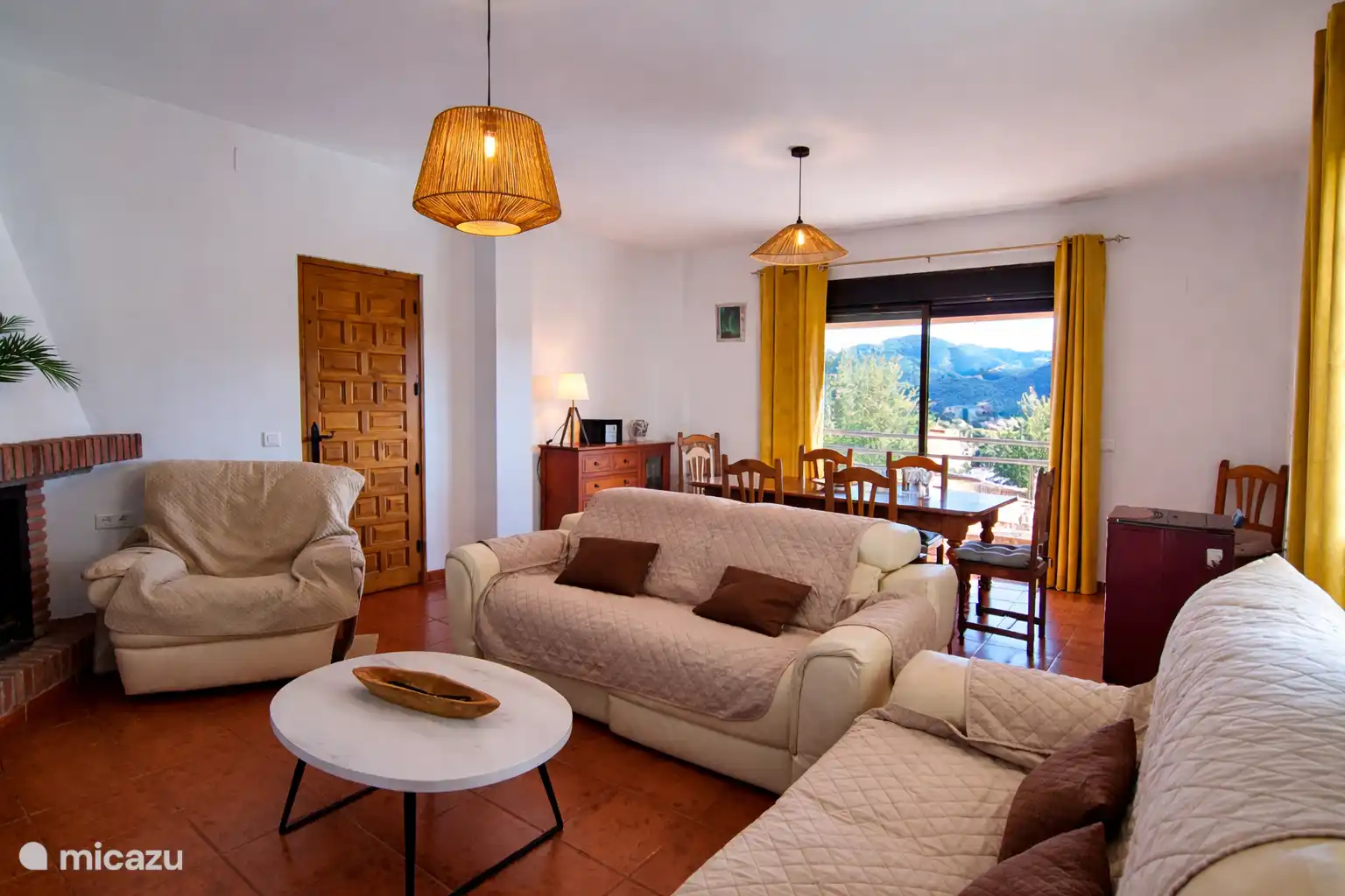 Een ruime woonkamer om heerlijk te ontspannen bij de open haard.