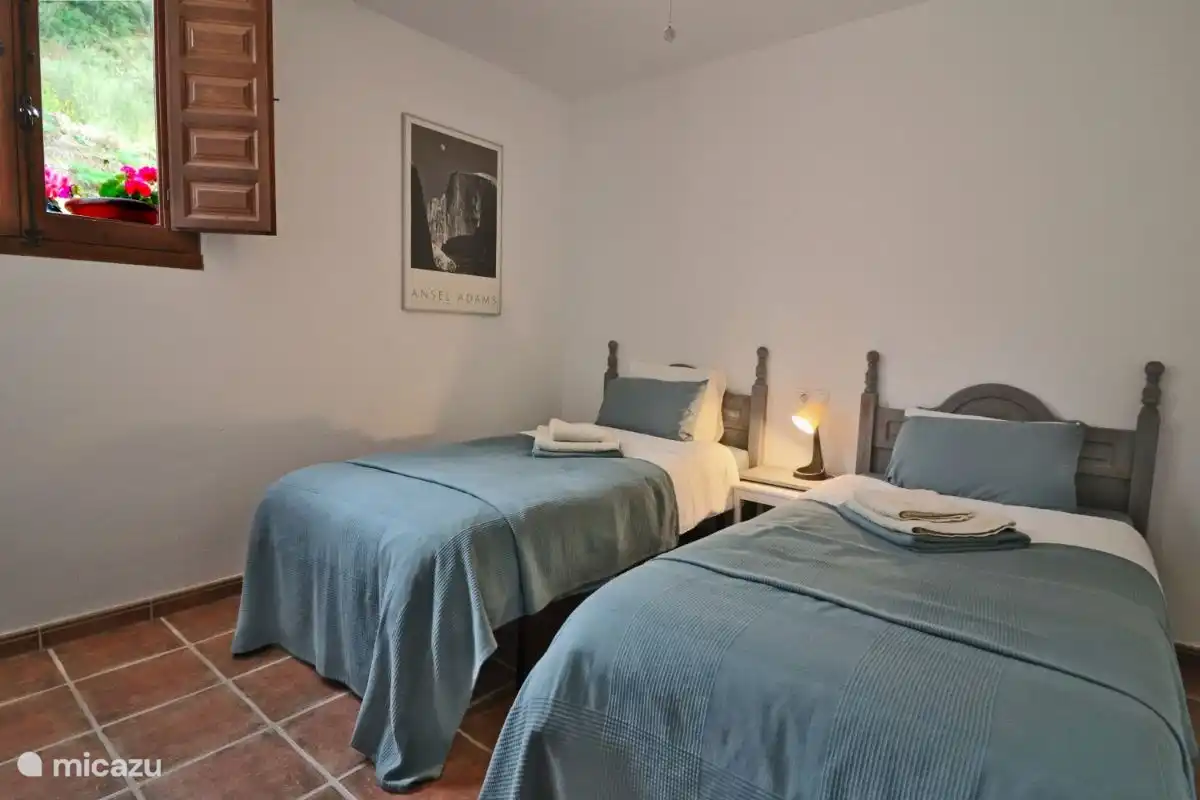 The first bedroom with two single beds