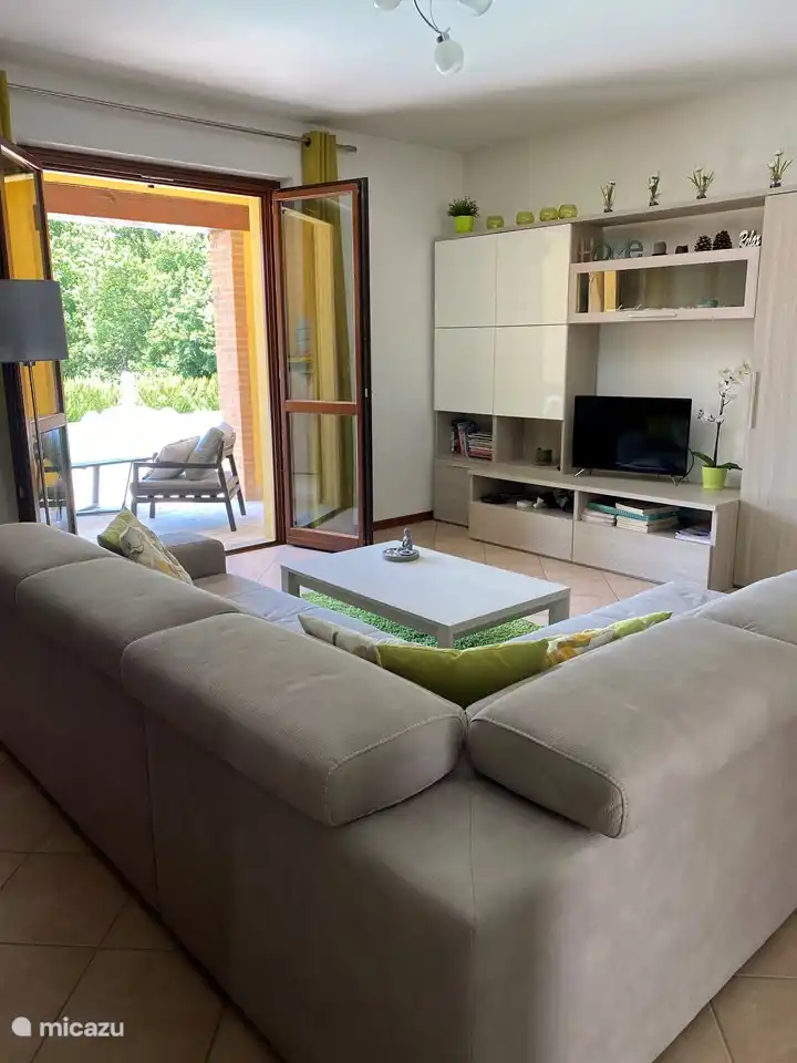 Spacious and comfortable sitting area with a view of the swimming pool