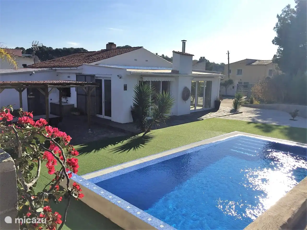Swimming pool, view on terrace and living room with large sliding windows