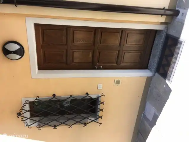 Our front door with artfully forged fencing in front of the window