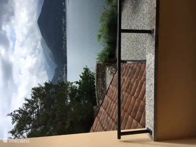 Adjacent to the bathroom is a balcony with a view of the garden and Lake Maggiore