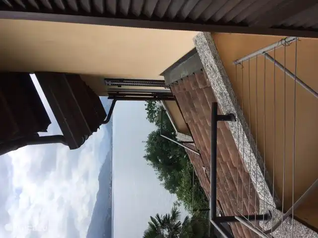 On the balcony there is a view to the south and the balcony of the other house