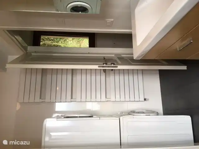 on the right the double washbasin with mirror cabinet above