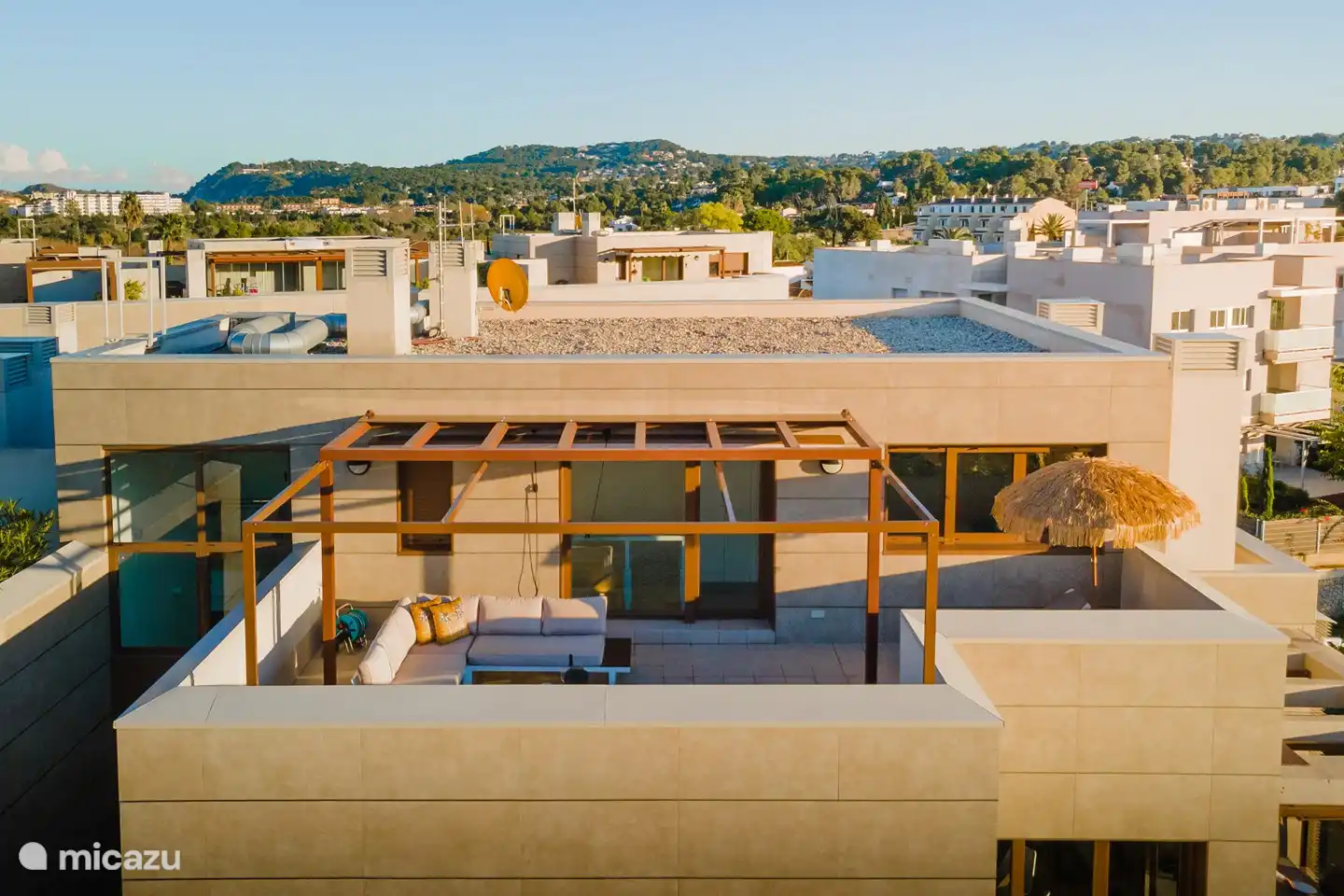 Roof terrace view with lovely lounge sofa and comfortable sunbeds.