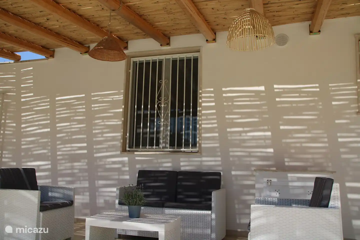 Seating area under the pergola at the pool terrace