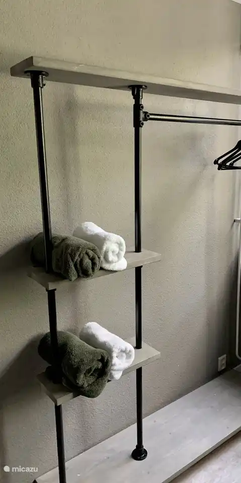 Kleiderständer mit Kleiderbügeln und Nachttische mit Schubladen im Hauptschlafzimmer