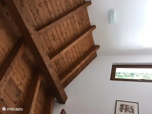 From your bed you look at this beautiful beamed ceiling.