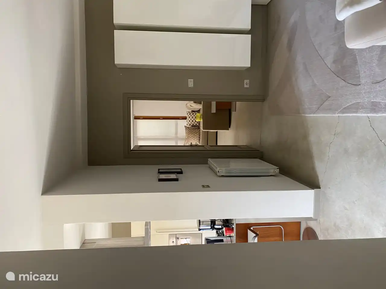 Doorkijkje naar ruime slaapkamer met aangrenzende badkamer op de begane grond 