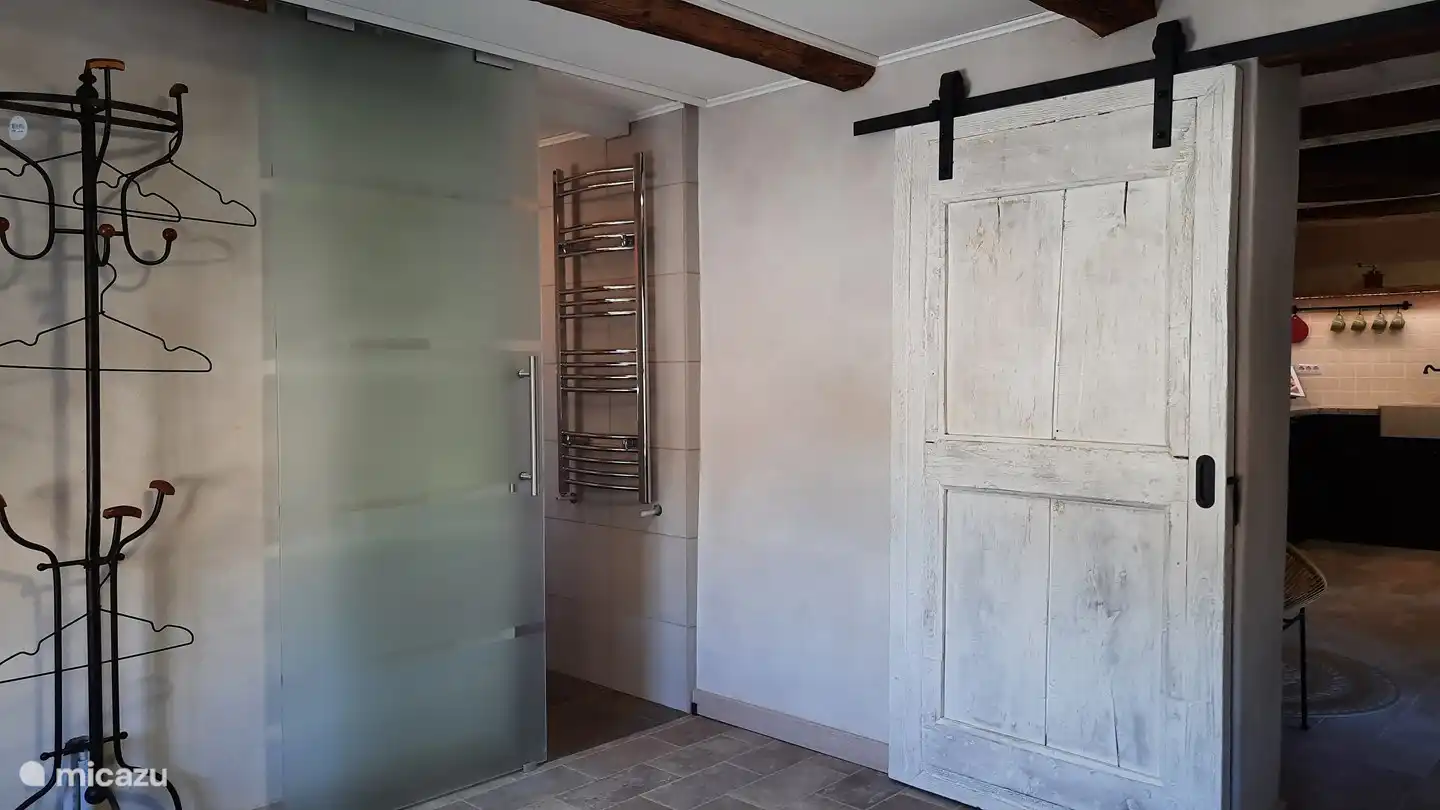 Our door is an original eye-catcher from the early days of the house, completely restored with an eye for detail. Its authentic character and charm have been preserved, so that it still radiates the warmth of the past.