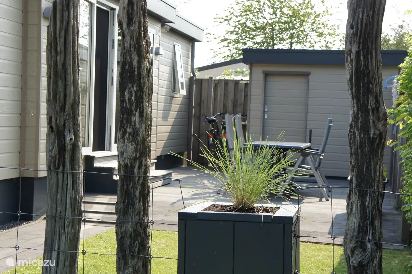 Terras met tuinstoelen en tafels en parasol