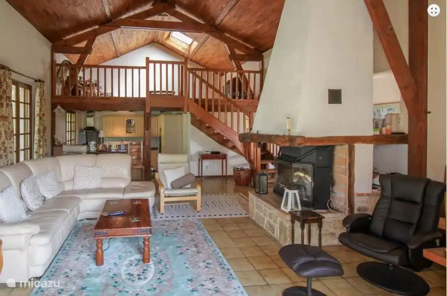 The chapel-style living room is spacious and airy, with a view of the mezzanine and kitchen.