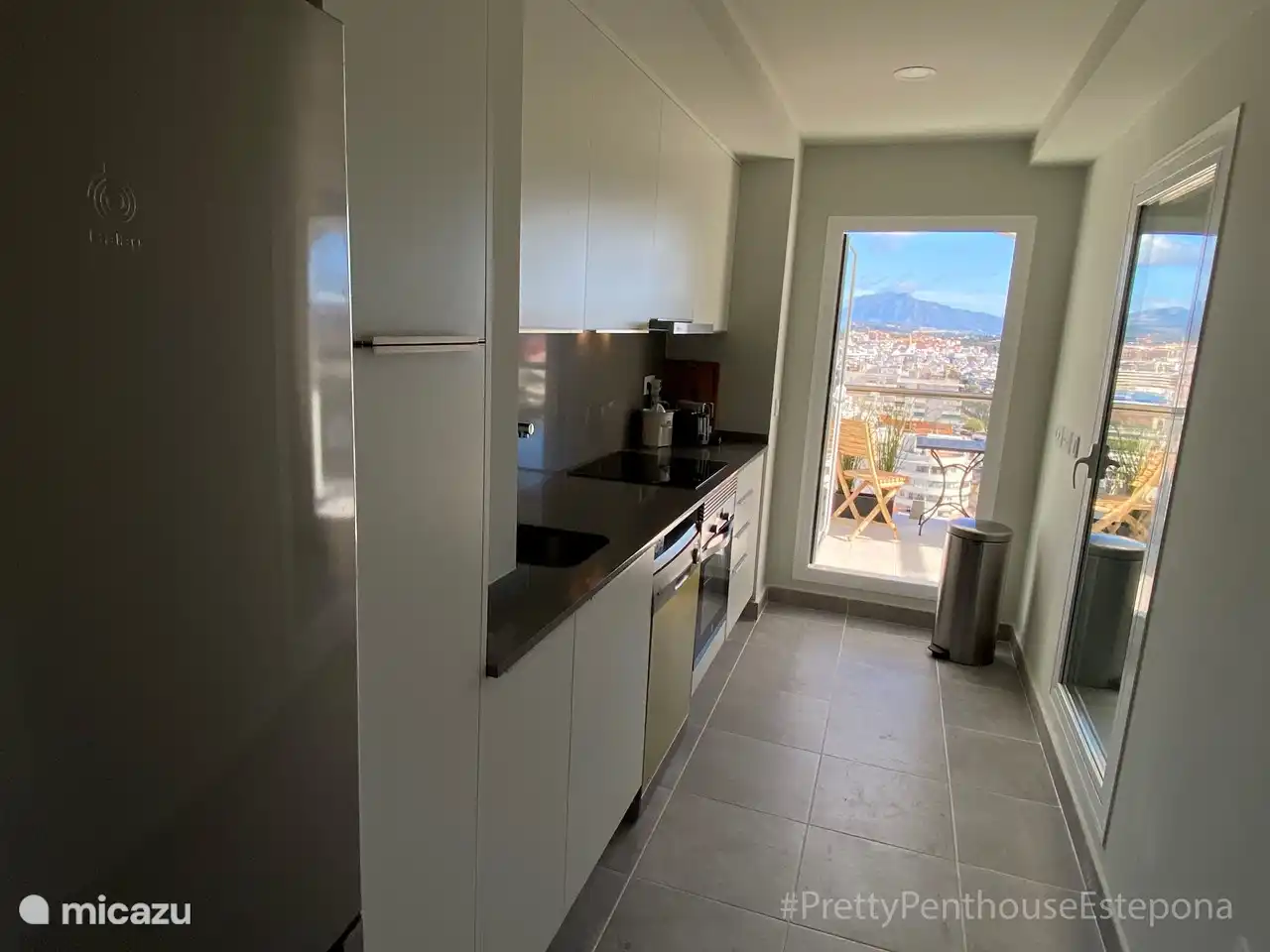 Kitchen with fridge freezer, oven, microwave, washing machine, dryer, Nespresso, kettle.