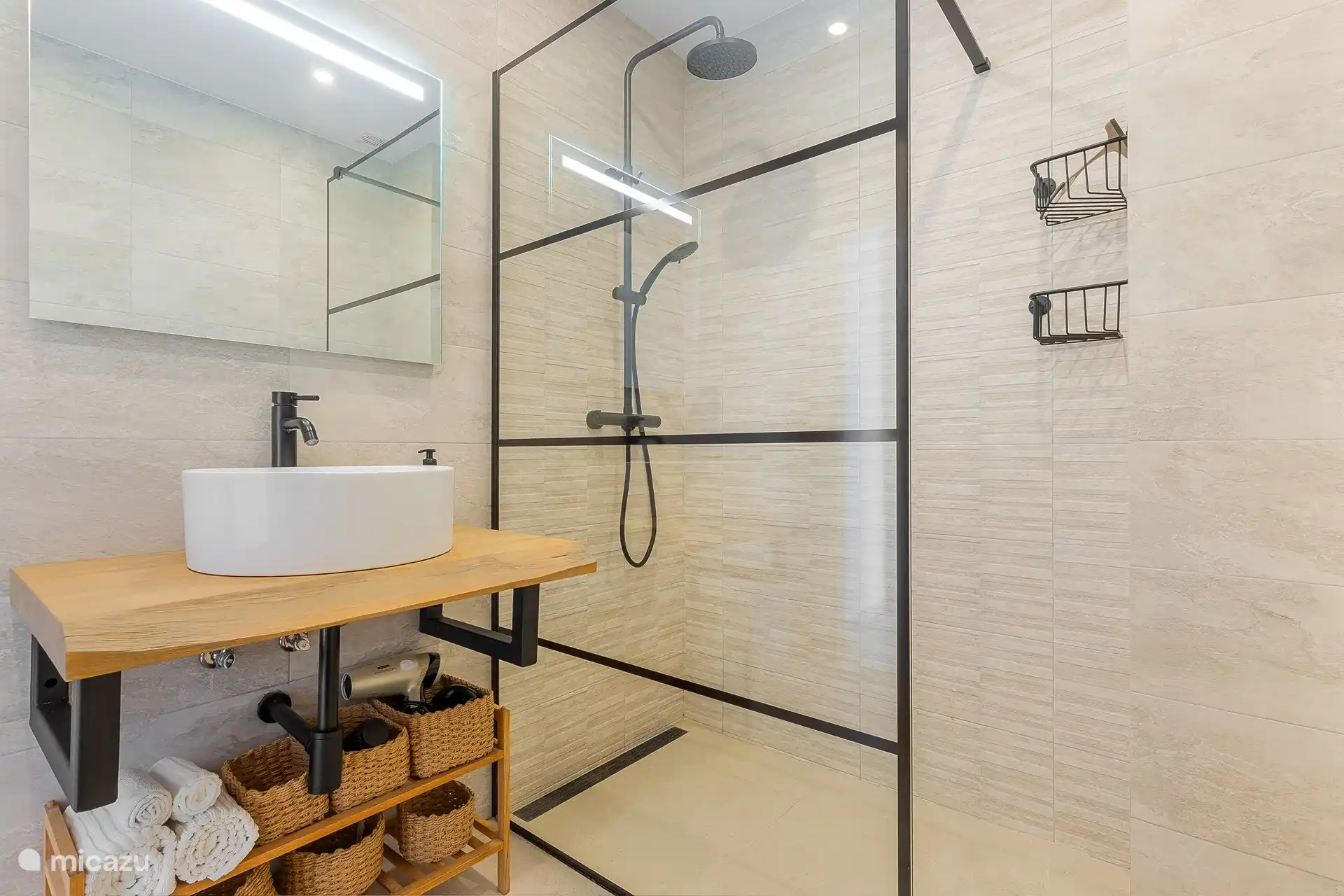 Stylish bathroom with rain shower and modern amenities.