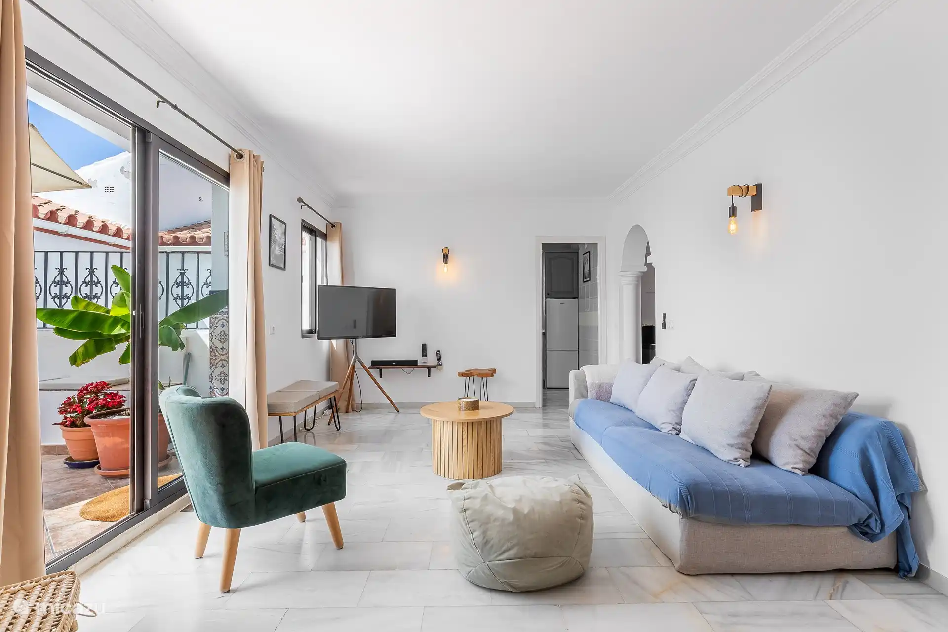 Spacious living room with fresh décor and large windows.