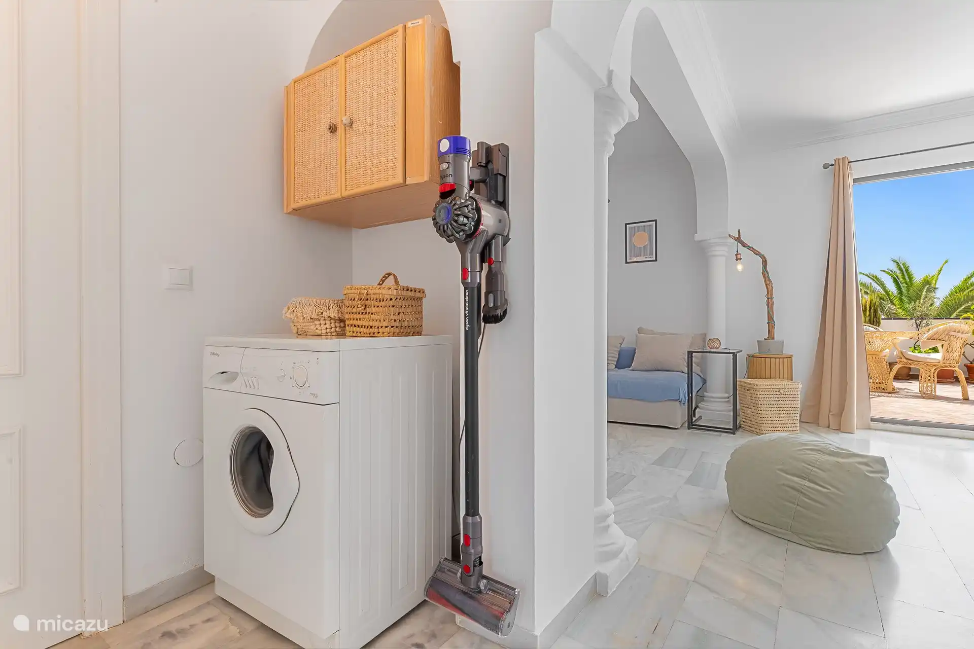 Practical corner with washing machine. Dyson vacuum cleaner and drying rack for your convenience.