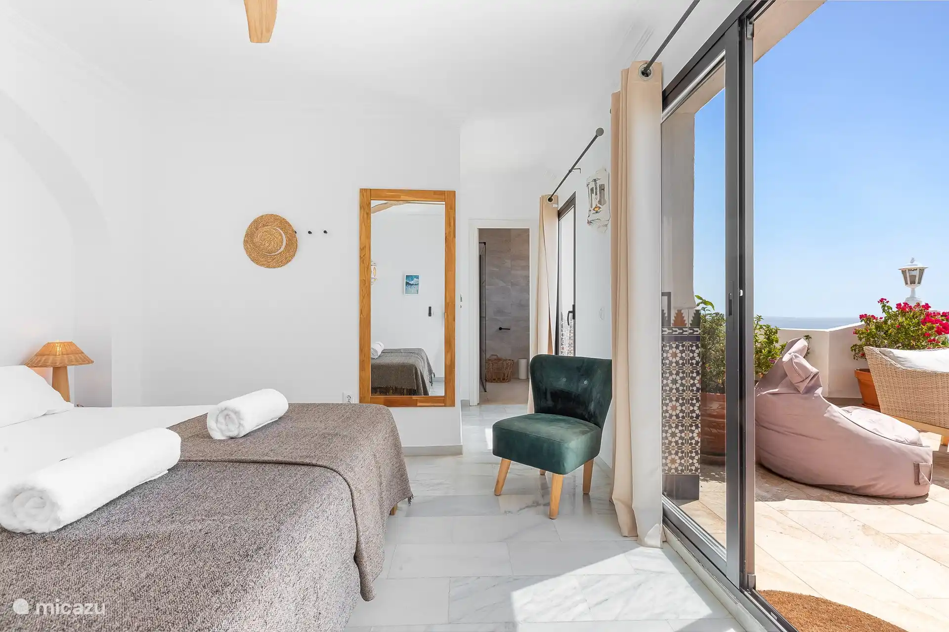 Master bedroom with a comfortable double bed and private access to the terrace.