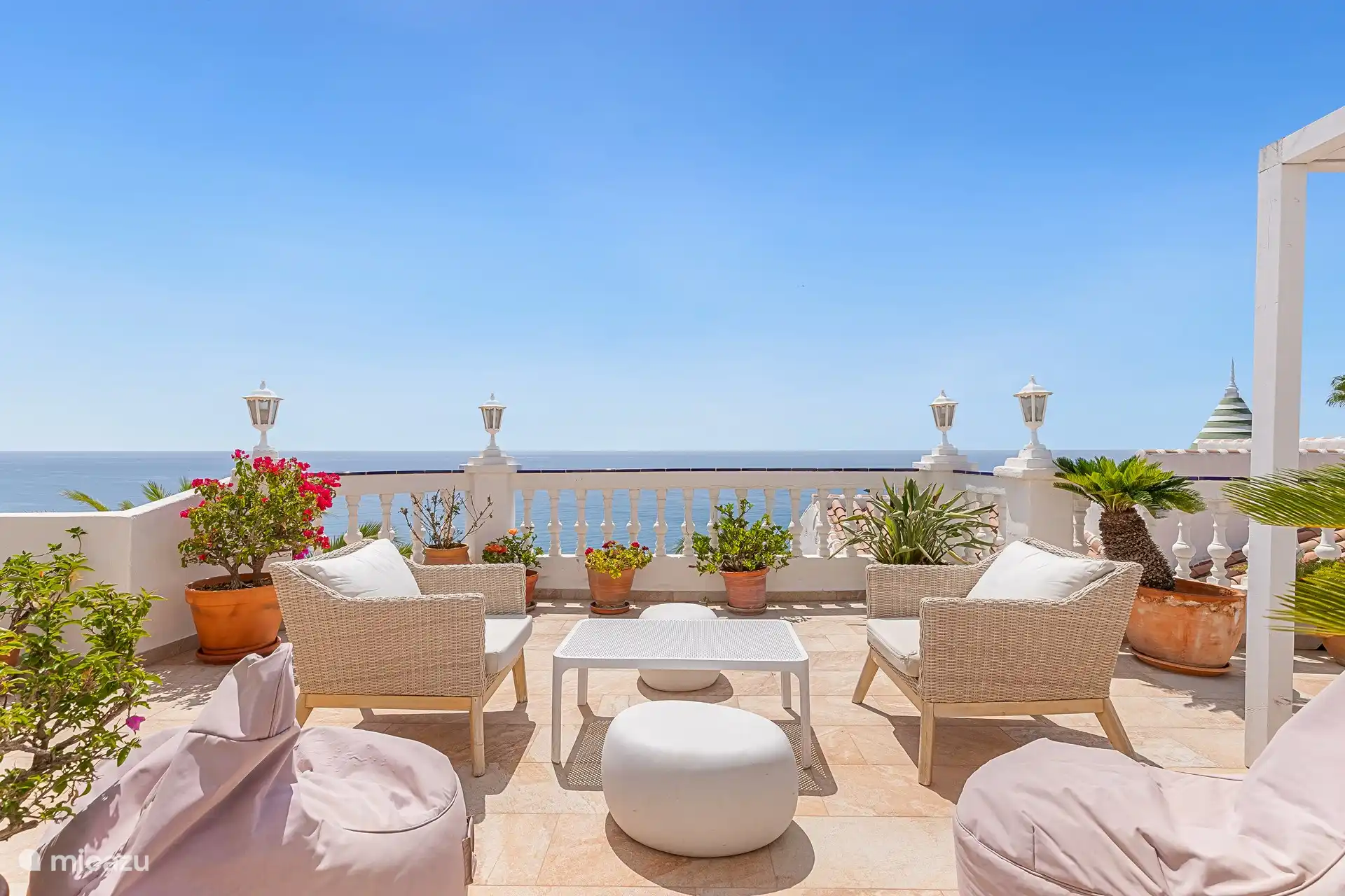 Enjoy the view from the sunny terrace with comfortable seating.