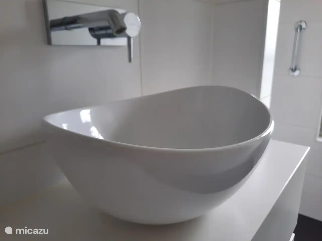 The bathroom with vanity unit and hair dryer