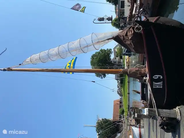A fishing vessel with the old wharf in Harderwijk in the background is a stone's throw away