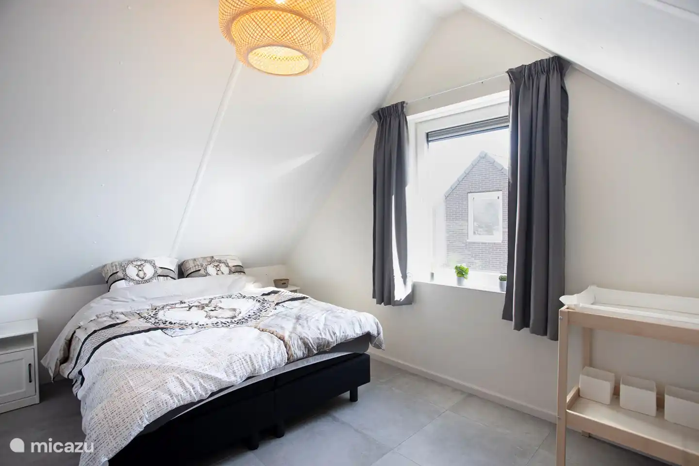 Bedroom 1 with 2 person box spring. A cot and changing facilities for the little one.