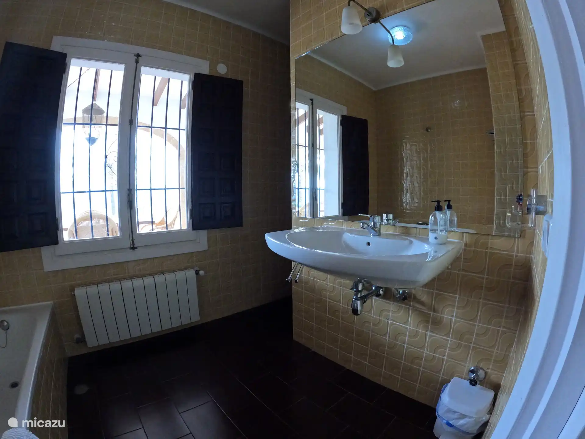 the bathroom with bath, walk-in shower and toilet