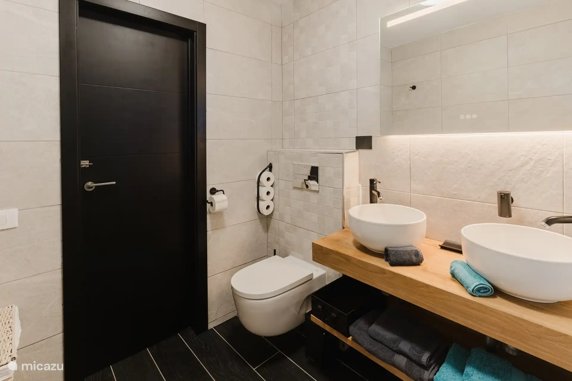 badkamer met dubbele wasbak en toilet