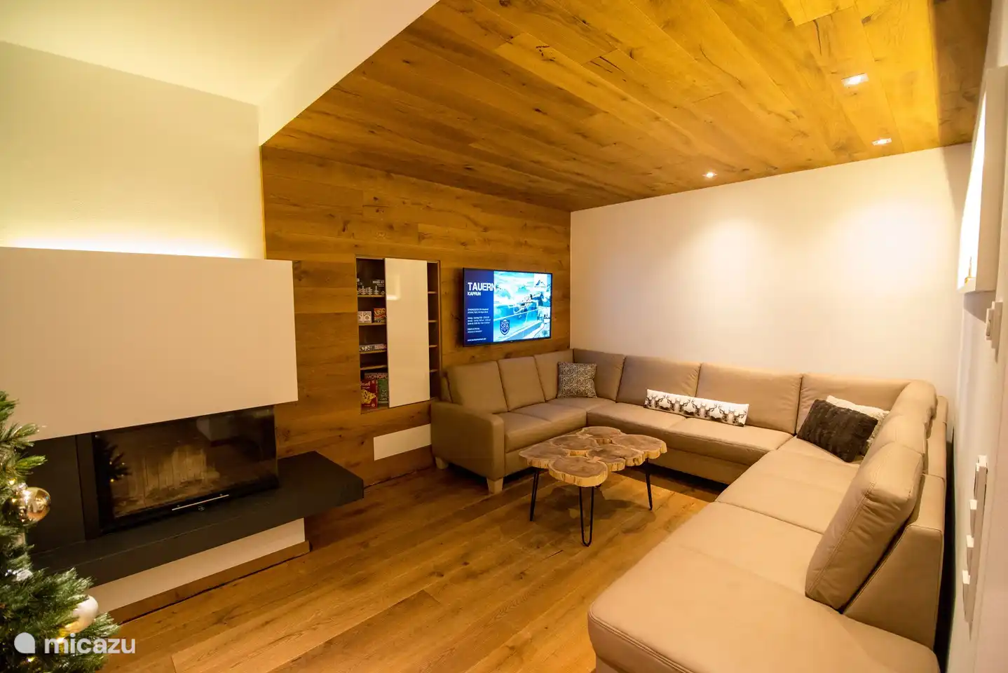 Sitting area with spacious sofa, TV, board games and fireplace.