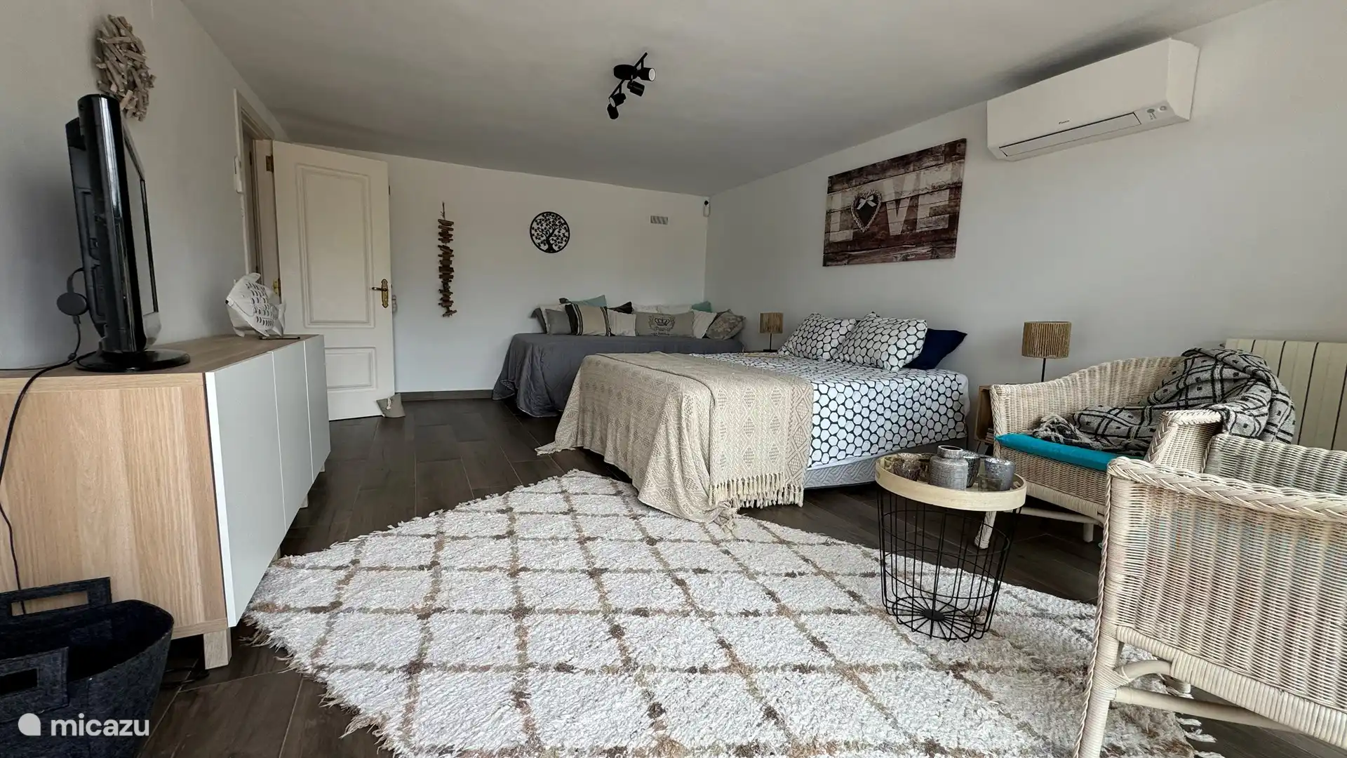 Large room 1 downstairs with a view of the pool. Like other rooms, this one is equipped with air conditioning.