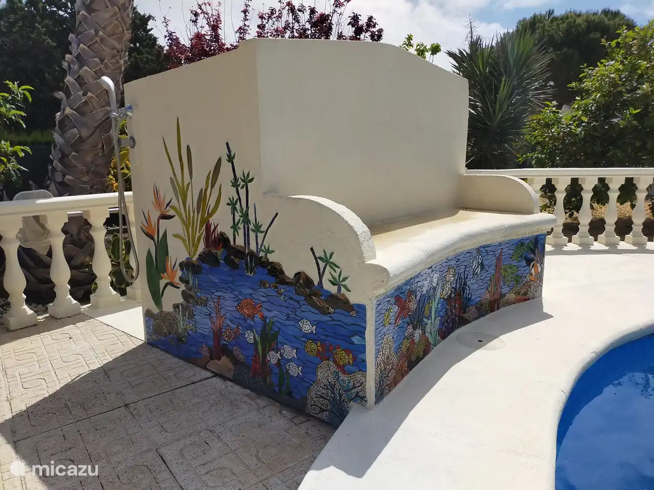 Het zwembadbankje is voorzien van een prachtig mozaiek