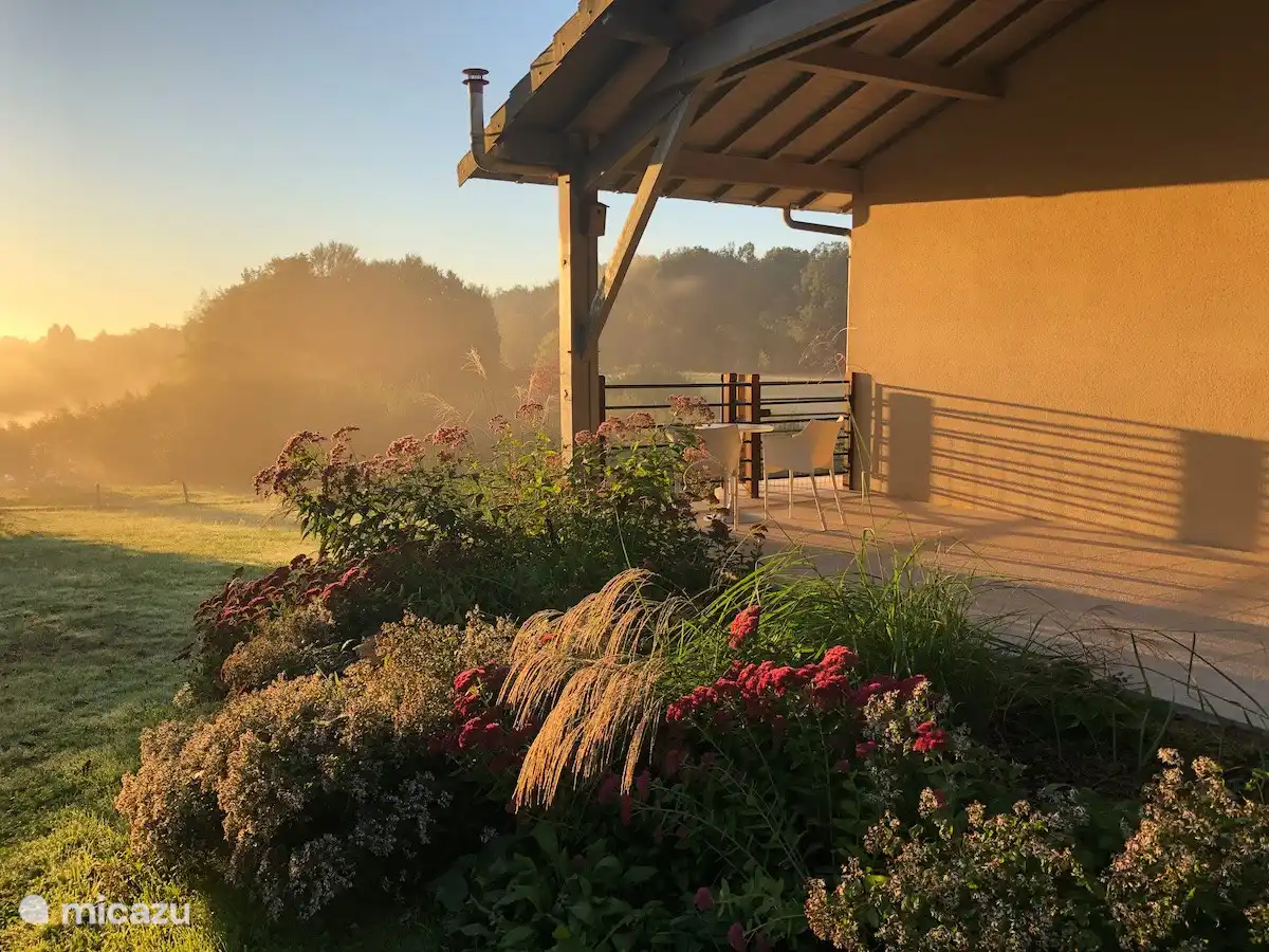 Flowerbed and covered terrace on the east side of our house.