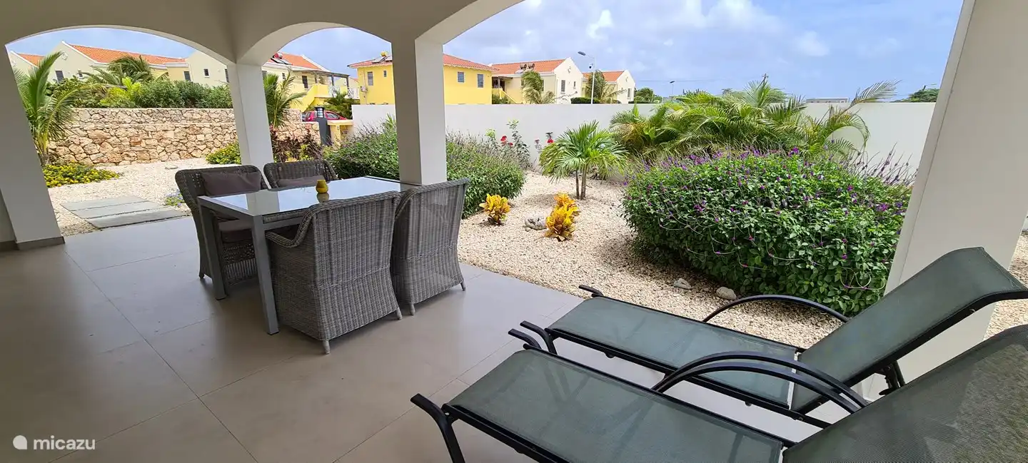 Covered terrace with garden view.