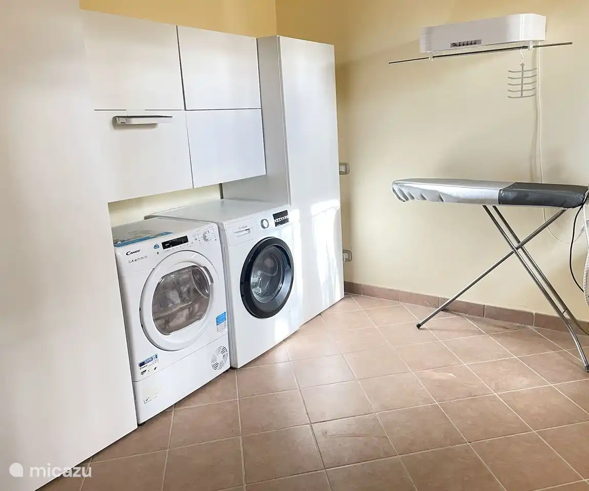 Laundry room with washing machine, dryer, ironing board and iron